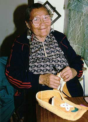 Jessie Joe sewing a moccassin